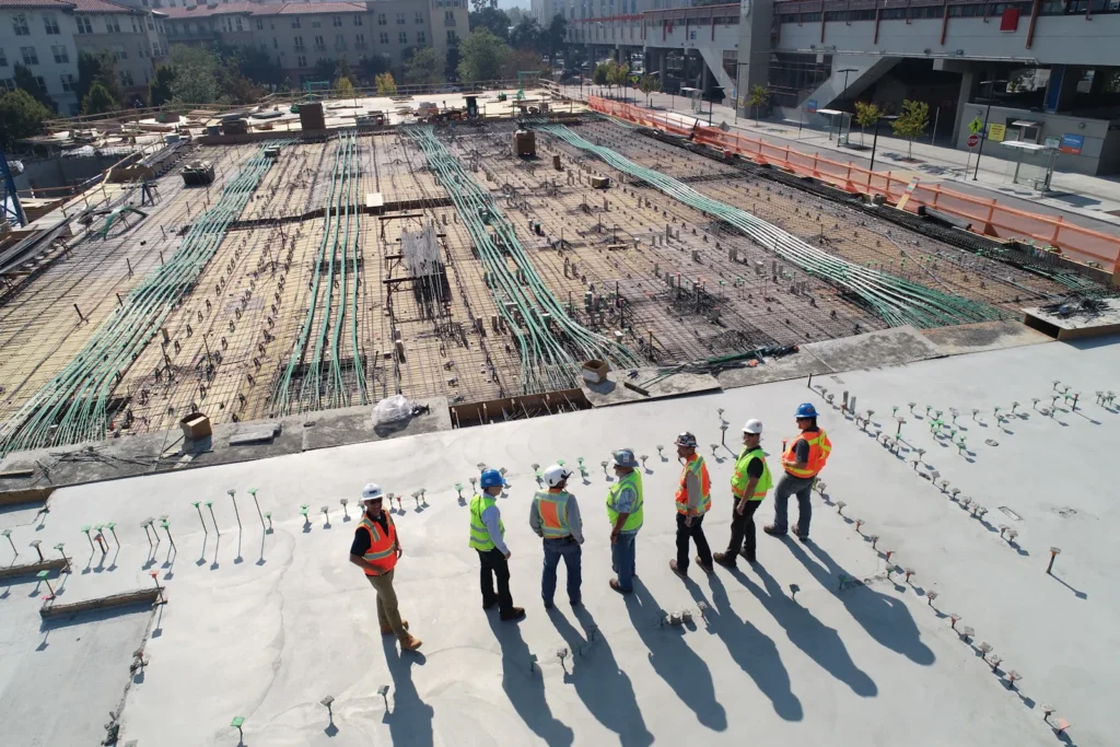Aerial view of an active commercial construction site with crews at work