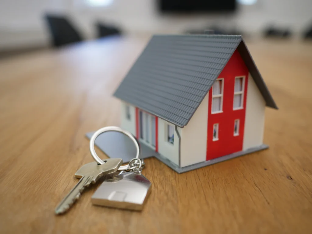House keys beside a small model house